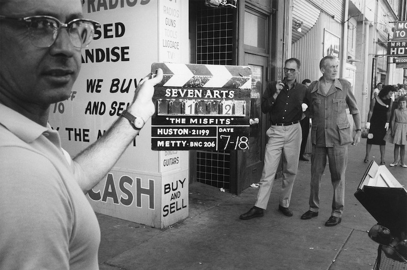 The first day of shooting, John Huston and Arthur Miller watching in the background. © Inge Morath/Magnum Photos